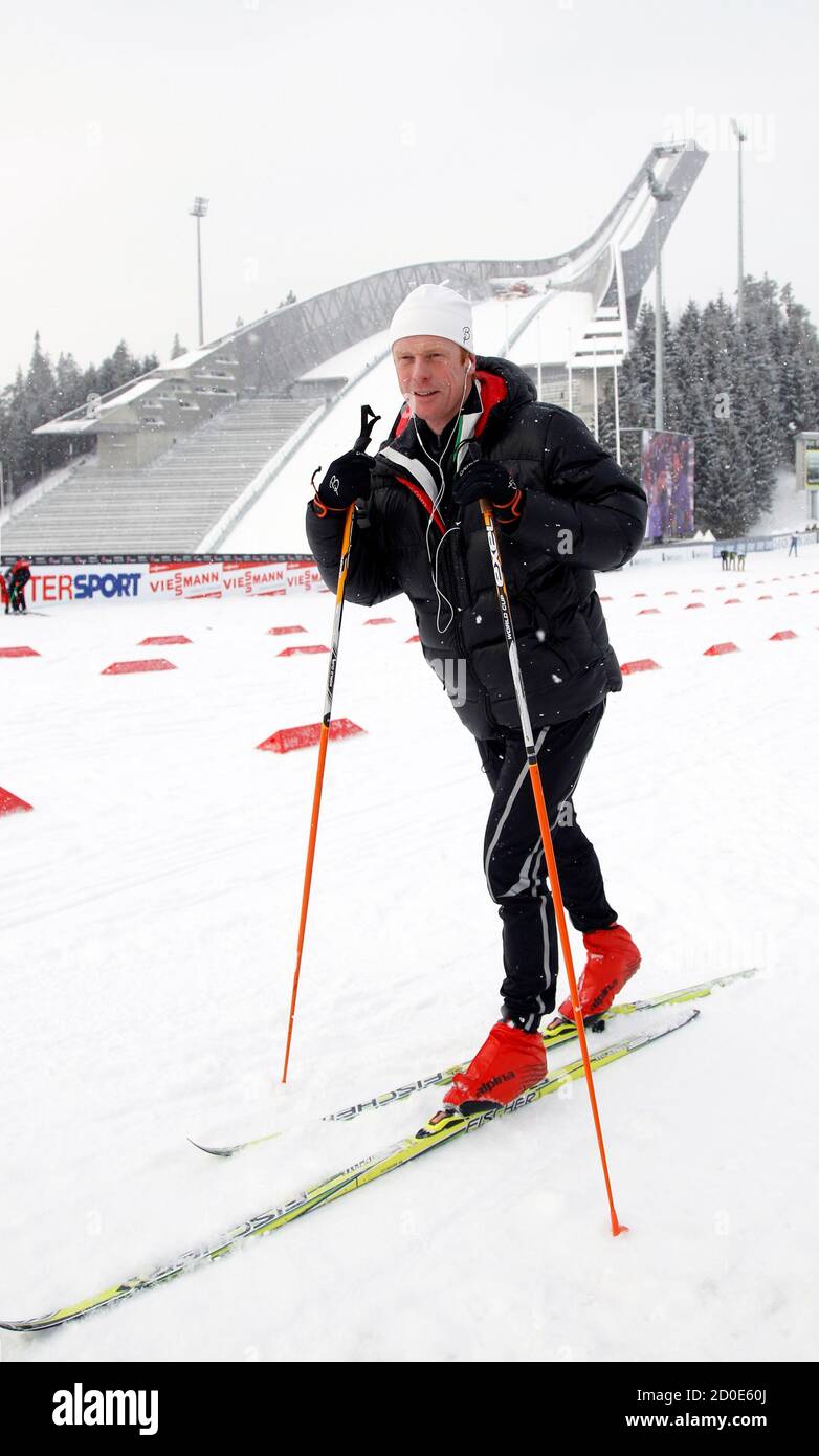 Norway's former cross country skier Bjorn Daehlie runs on a cross country  track in front of the Holmenkollen ski jump at the at the Nordic Ski World  Championships in Oslo, February 23,