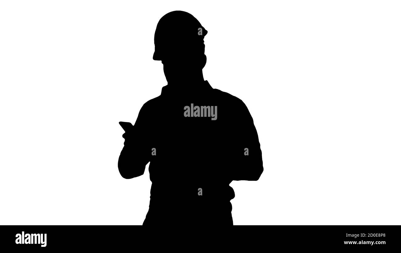 Engineer walking and using smartphone, Alpha Channel Stock Photo