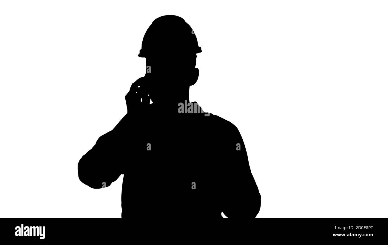 Engineer in white shirt and hard hat talking on his mobile phone Stock Photo