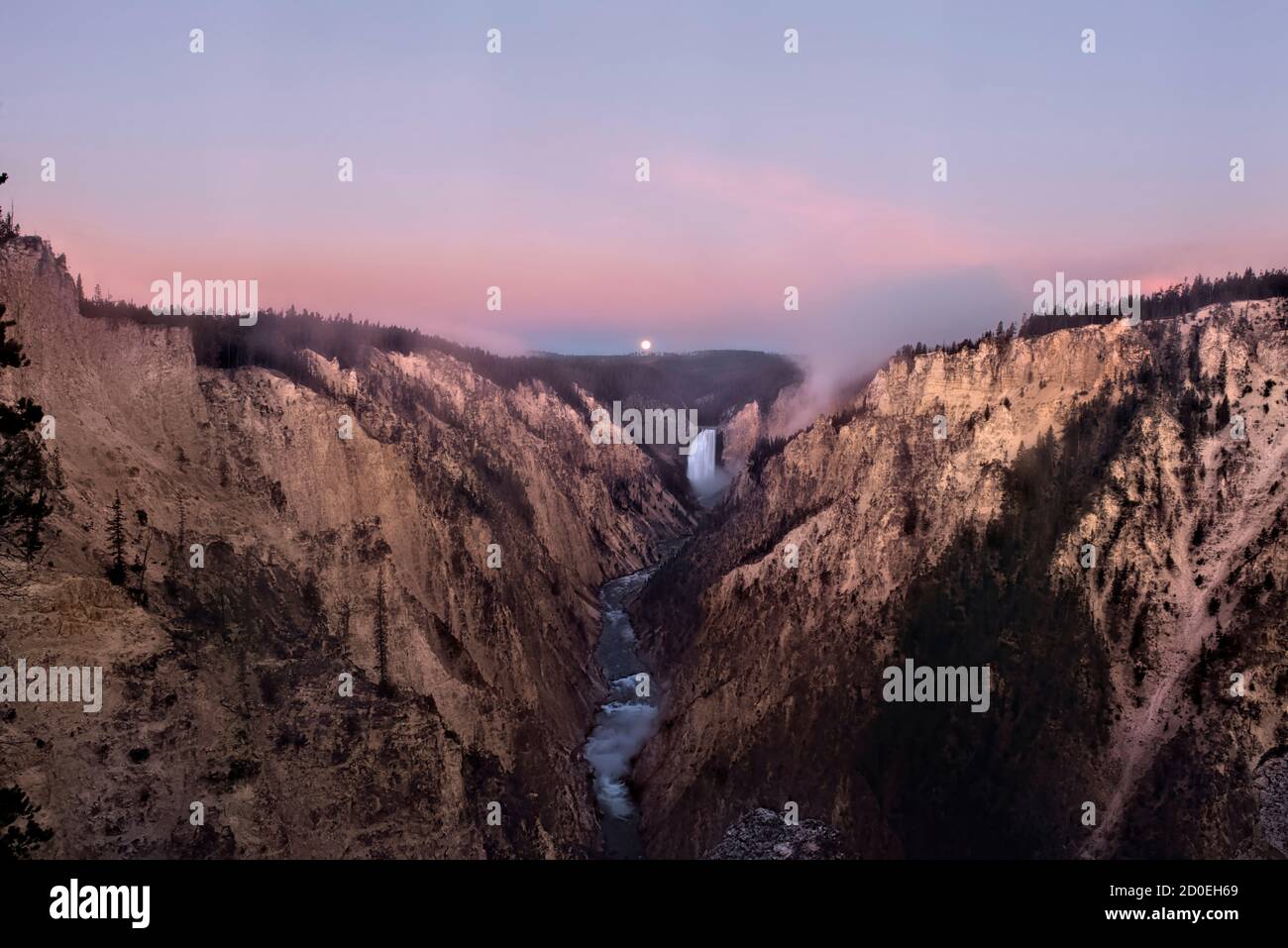 Moon set at sunrise, Lower Falls of the Yellowstone River and Grand Canyon, Yellowstone National Park, Wyoming, USA Stock Photo
