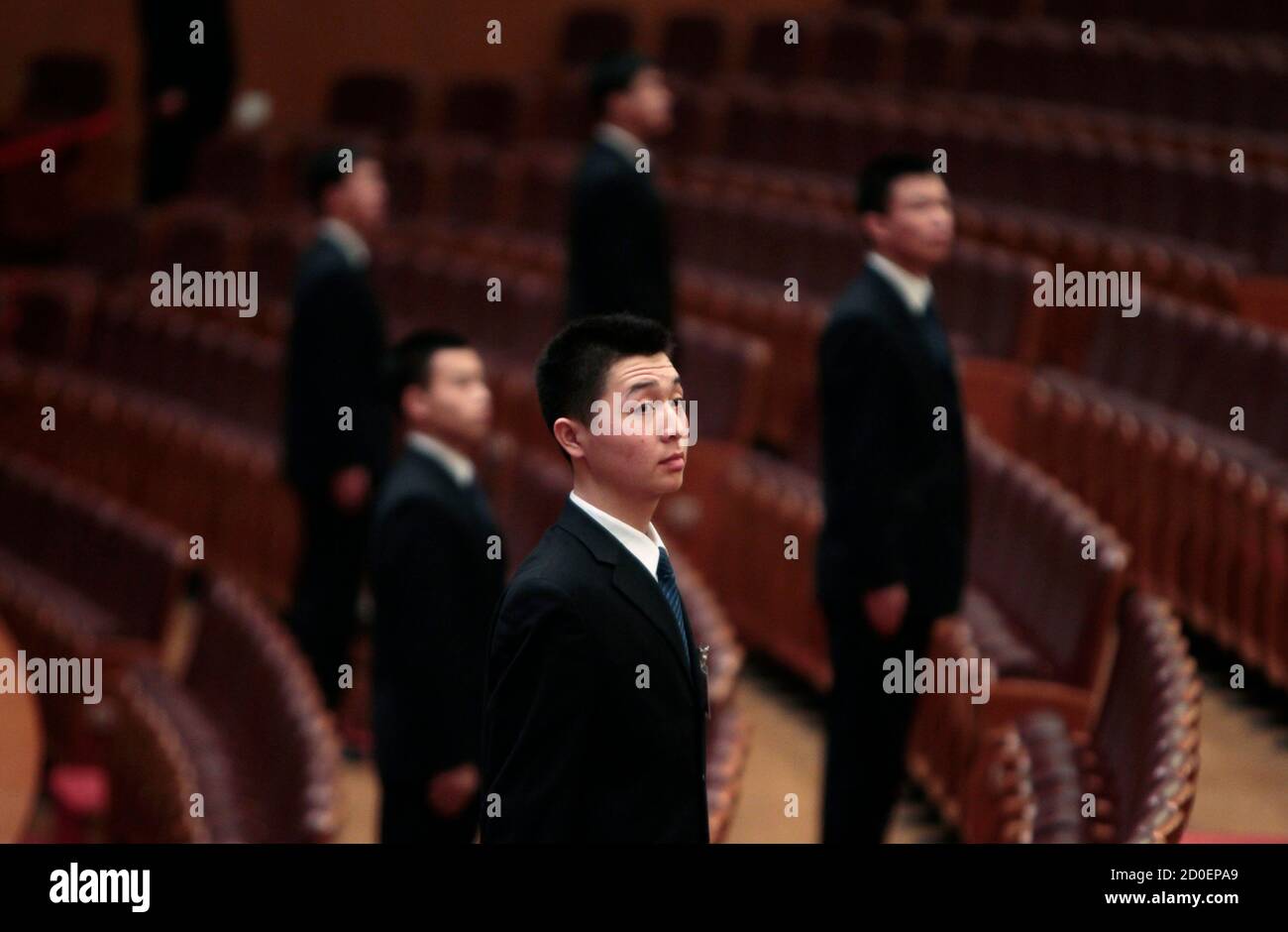 Security officers stand guard during the second plenary meeting of the National People's Congress (NPC), China's parliament, at the Great Hall of the People in Beijing March 8, 2012. China's parliament unveiled legislation on Thursday to solidify police powers to secretly hold dissidents and other suspects of state security crimes, a year after a spasm of clandestine detentions drew international condemnation. REUTERS/Jason Lee (CHINA - Tags: POLITICS CRIME LAW) Stock Photo