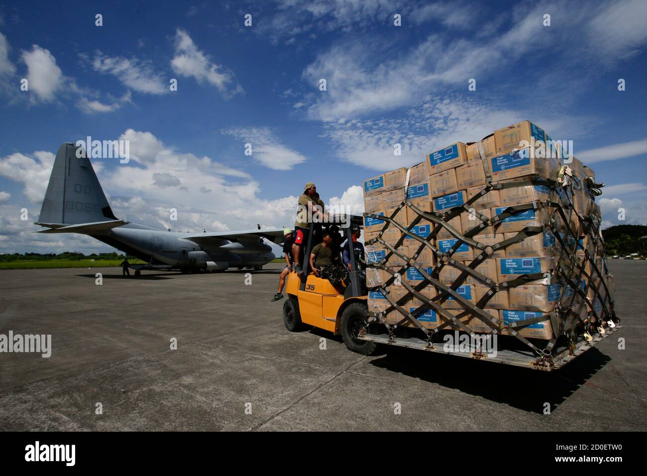 Philippine Army personnel unload relief goods to be transported to regions affected by Typhoon Bopha, from the Marine Corps KC-130J Hercules aircraft inside the International Airport in Davao, Mindanao December 15, 2012. United States Marines together with the Philippine Armed forces and various non-profit organisations continue to work hand in hand to provide humanitarian assistance and disaster relief support  at the request of the Philippines government, in the wake of Typhoon  Bopha, which made landfall on December 4, 2012, according to a press release. REUTERS/John Javellana (PHILIPPINES  Stock Photo
