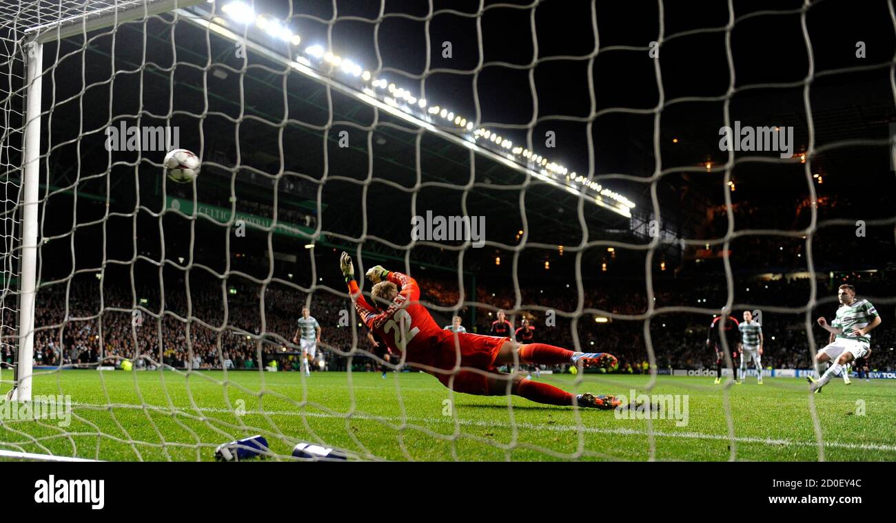 Celtic's James Forrest (R) scores from a penalty against Ajax's goalkeeper Jasper Cillessen during their Champions League soccer match at Celtic Park Stadium, Scotland October 22, 2013. REUTERS/Russell Cheyne (BRITAIN - Tags: SPORT SOCCER) Stock Photo