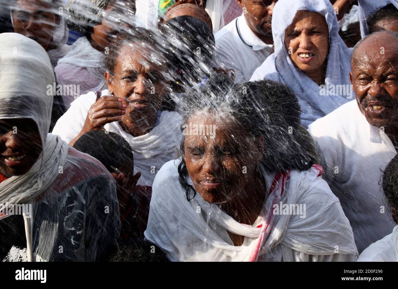 Ethiopian Orthodox worshippers are sprayed with baptism water during annual Epiphany celebrations called "Timket" in Addis Ababa January 19, 2015. "Timket" commemorates Jesus Christ's baptism in the Jordan River by John the Baptist. REUTERS/Tiksa Negeri (ETHIOPIA - Tags: RELIGION SOCIETY) Stock Photo