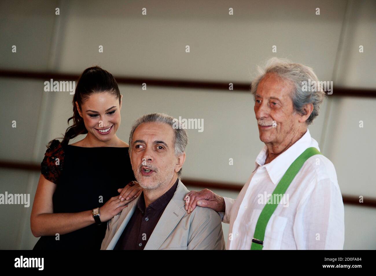 Cast members Aida Folch (L) and Jean Rochefort (R) pose with director Fernando Trueba at a photocall to promote 'El Artista y La Modelo' (The artist and the model) at the Kursaal Centre on the fourth day of the San Sebastian Film Festival September 24, 2012. The film is part of the festival's Official Selection. REUTERS/Vincent West (SPAIN - Tags: ENTERTAINMENT) Stock Photo