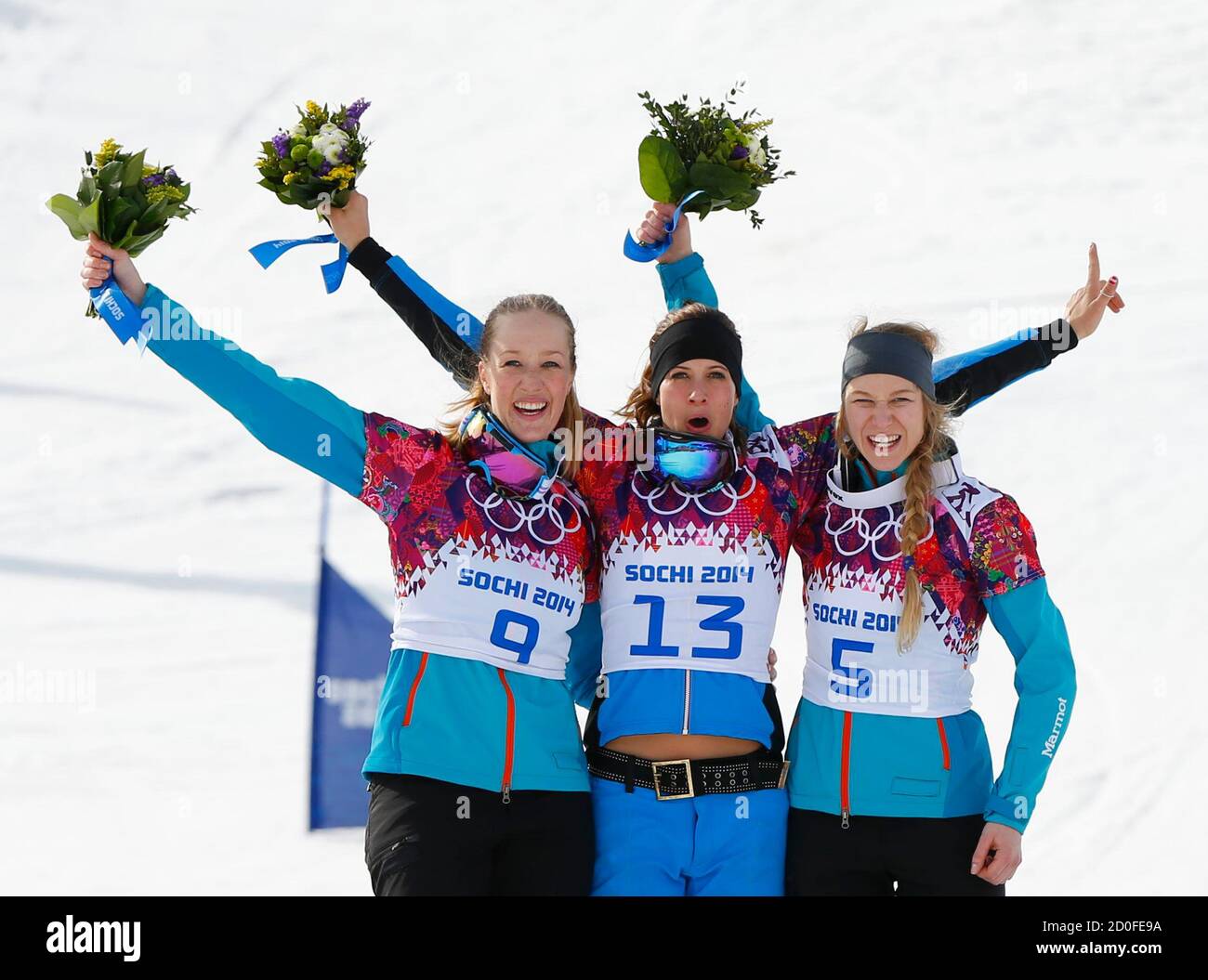 to R) Germany's second-placed Anke Karstens, Austria's first-placed Julia Dujmovits and Germany's third-placed Amelie Kober celebrate on the podium during the flower ceremony for women's parallel slalom snowboard event at