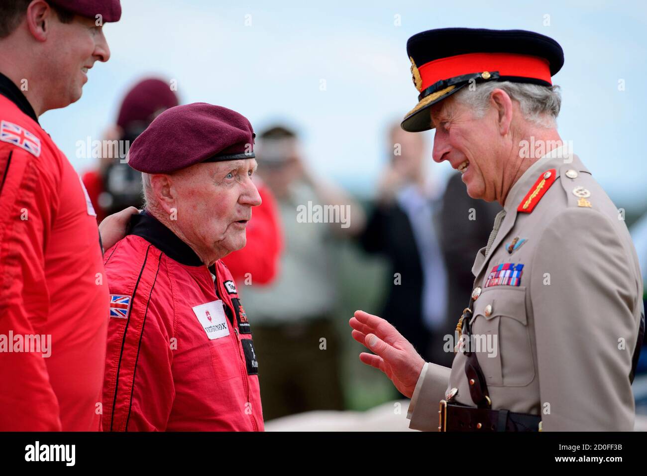 Britain's Prince Charles (R), Prince of Wales, speaks with British World War II veteran Jock Hutton (L), 89, after Hutton and teams of French, US, Canadian and British paratroopers jumped from aeroplanes during a D-Day commemoration in Ranville, northern France, on June 5, 2014. Some 3,000 veterans are among those attending ceremonies across the Normandy coastline where Allied forces landed in the largest seaborne invasion in history seventy years ago to help speed up the defeat of Nazi Germany in the Second World War.  REUTERS/Leon Neal/Pool   (FRANCE - Tags: ANNIVERSARY CONFLICT ROYALS ENTER Stock Photo