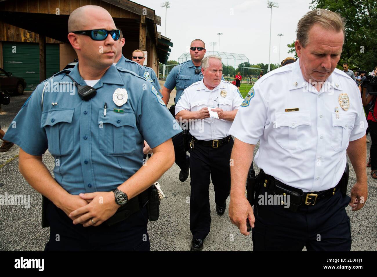 Ferguson Police Chief Thomas Jackson (C) walks away from a media availability regarding his office's handling of the release of information following the shooting of Michael Brown in Ferguson, Missouri August 15, 2014. Picture taken August 15, 2014. REUTERS/Lucas Jackson (UNITED STATES - Tags: CIVIL UNREST CRIME LAW POLITICS) Stock Photo
