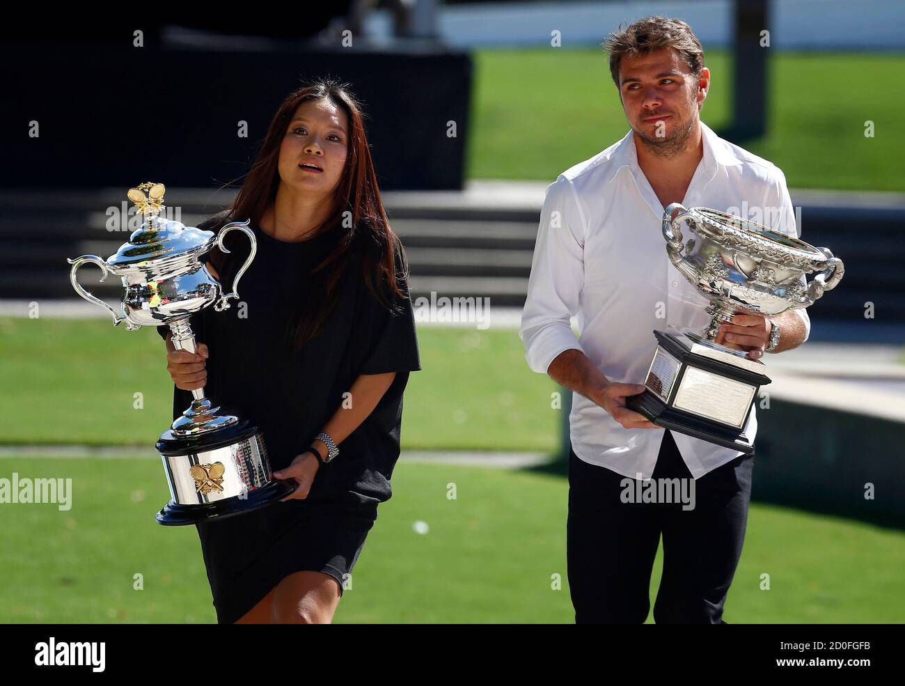 Current Australian Open tennis champions China's Li Na and Switzerland's  Stanislas Wawrinka carry the men's and women's singles trophies to the  official draw ceremony at the Rod Laver Arena in Melbourne Park