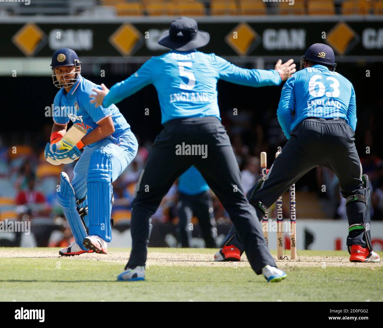 India's batsman Suresh Raina (L) is stumped by England's wicketkeeper Jos Buttler (R) off the bowling of Moeen Ali during their One Day International (ODI) tri-series cricket match in Brisbane, January 20, 2015.  REUTERS/Edgar Su   (AUSTRALIA - Tags: SPORT CRICKET) Stock Photo