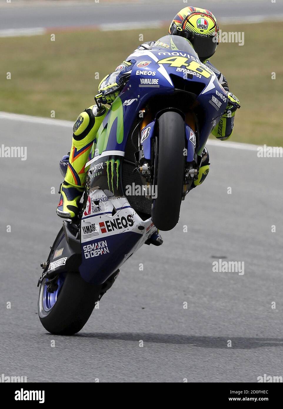 Yamaha Moto GP rider Valentino Rossi of Italy does a wheelie after the  qualifying session of the Catalunya Grand Prix at the Barcelona-Catalunya  circuit, in Montmelo near Barcelona, Spain, June 13, 2015.