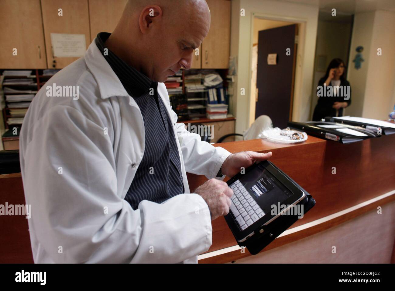 Doctor Nir Cohen Works With An Apple Ipad Before Visiting A Patient At The Mayanei Hayeshua