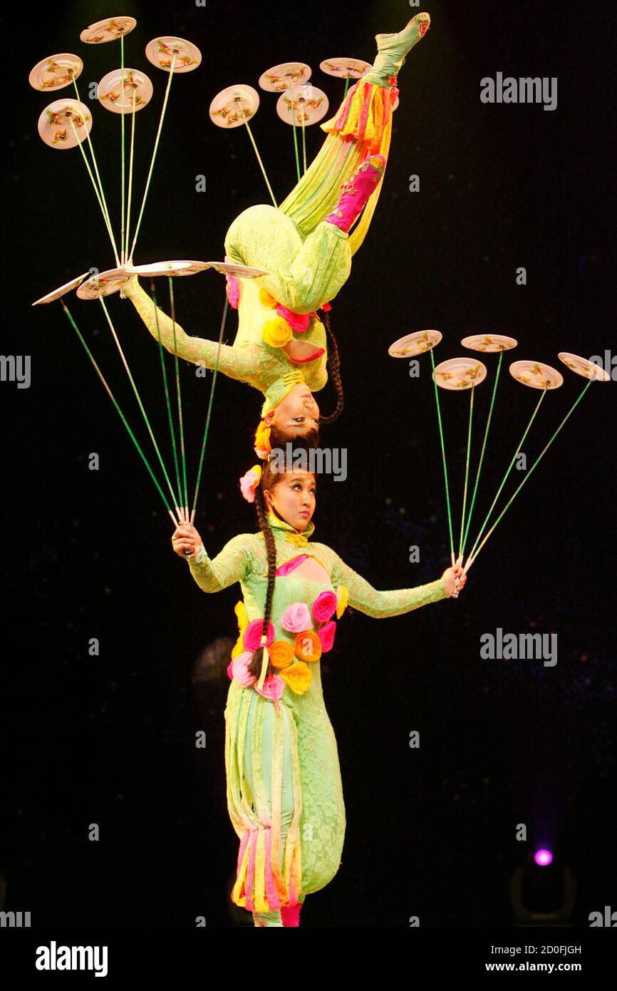 Chinese acrobats perform their plate-spinning skills during the "Grand  China National Acrobatic Circus Splendide!" at Araneta Coliseum in Quezon  City Metro Manila December 28, 2010. Over 100 award-winning acrobats,  jugglers, aerialists, contortionists