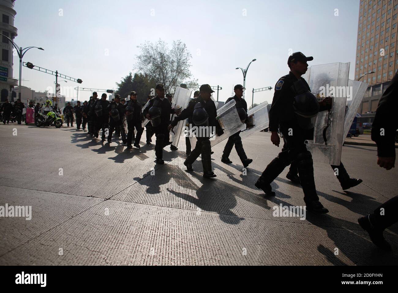 Riot policemen march toward the perimeter of the Senate building to prevent demonstrations in Mexico City December 4, 2013. Mexican lawmakers are poised to send a landmark energy bill to Senate committees to start debate on a cornerstone of President Enrique Pena Nieto's economic reform drive, a top ruling party lawmaker said on Wednesday. The bill, which would open Mexico's state-dominated energy sector to private investment in a bid to boost lagging output and growth in Latin America's No.2 economy, will still need approval of the Senate and lower house of Congress. REUTERS/Tomas Bravo (MEXI Stock Photo