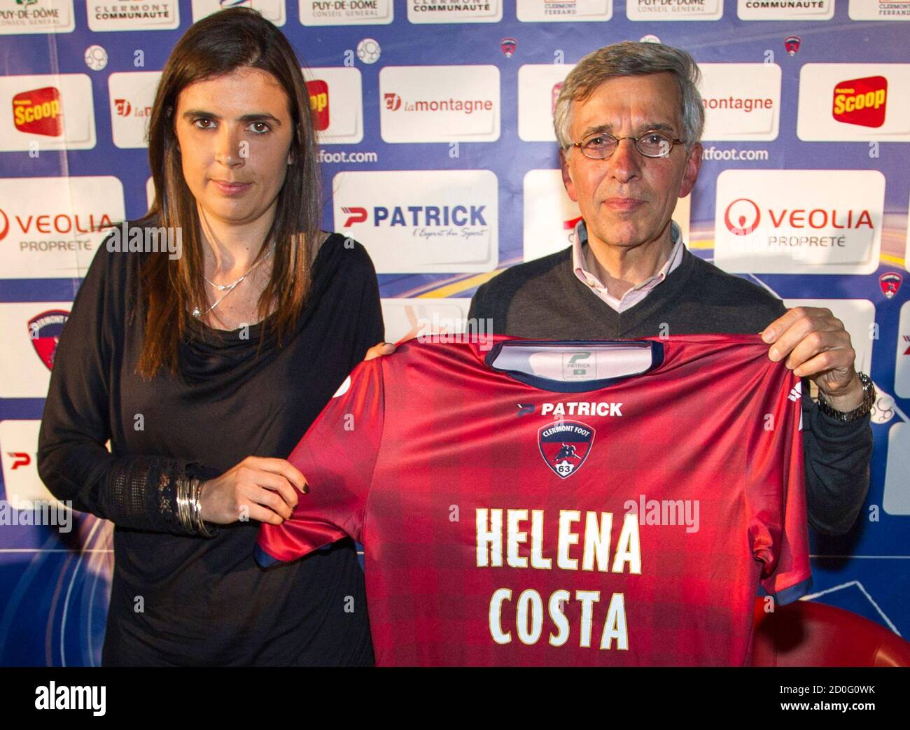Helena Costa (L), the newly-name soccer coach for French club Clermont Foot  Auvergne 63, holds her new jersey with the Claude Michy, the club  president, during a news conference at the stadium