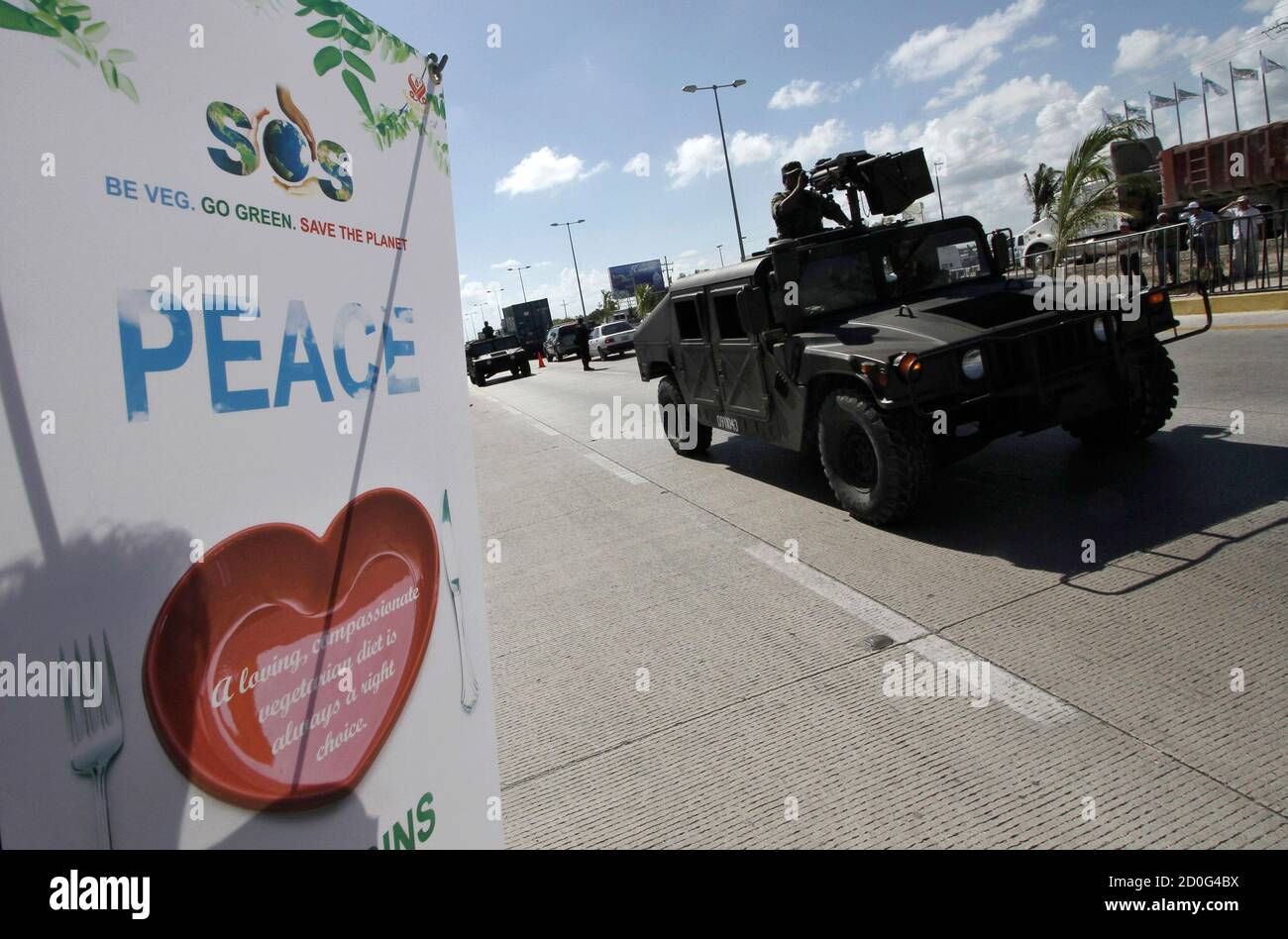Soldiers lead a convoy of armoured personnel carriers while patrolling the area surrounding the venue of climate talks in Cancun November 29, 2010. U.N. climate talks with almost 200 nations are starting in Cancun on Monday to discuss steps to combat climate change after a summit in Denmark in 2009 came up with only a non-binding Copenhagen Accord.  REUTERS/Gerardo Garcia (MEXICO - Tags: ENVIRONMENT MILITARY) Stock Photo
