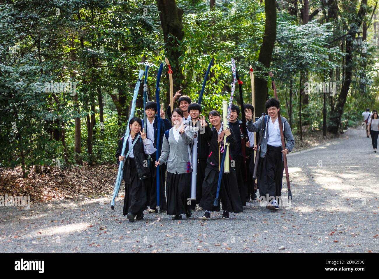 March 2018 - Meiji Jingu Shrine, Tokyo, Japan: Teenagers carrying their Kyudo archery bows Stock Photo