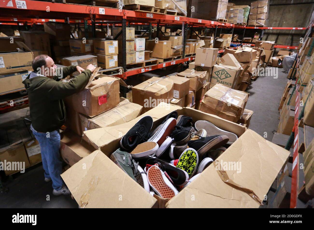 Operation USA warehouse manager Bruce Brinker prepares boxes of Vans shoes  to be sent in relief shipments to be sent to the Philippines for victims of  Typhoon Haiyan, from Wilmington, California November
