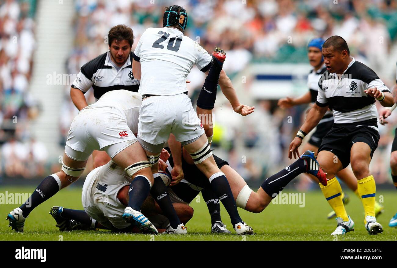 Dave Ewers (L) and James Gaskell (2nd L) of England upend Mamuka Gorgodze (C) of the Barbarians during their rugby match at Twickenham in London, June 1, 2014.  REUTERS/Andrew Winning   (BRITAIN - Tags: SPORT) Stock Photo