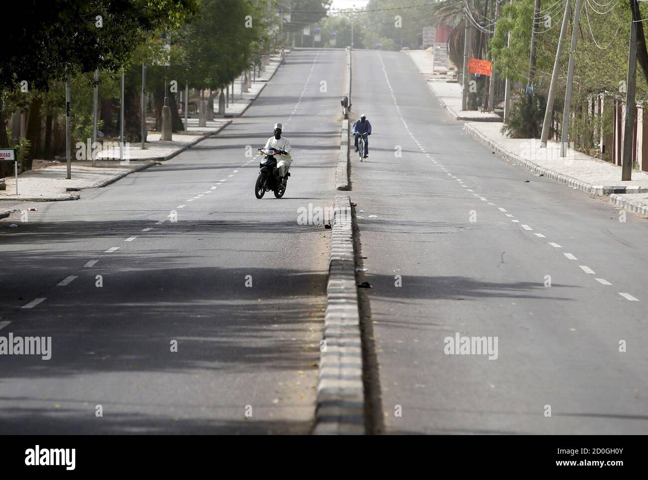 A man rides a motorcycle on an empty street during elections in Kano March  28, 2015. Police banned the movement of vehicles in Kano except for  vehicles with permission. Nigerians voted on