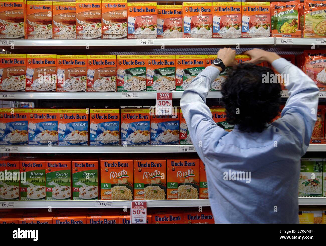 an employee arranges packets of rice at the leman shopping centre in crissier near lausanne august 15 2011 switzerland s second largest retail group coop said on sunday that they will stop selling certain