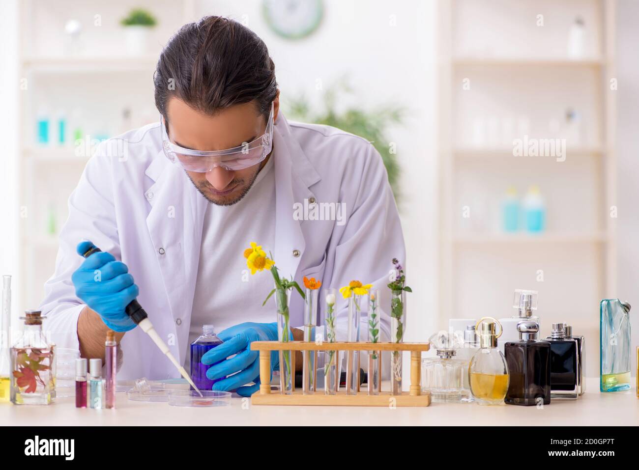 Young chemist in perfume synthesis concept Stock Photo Alamy