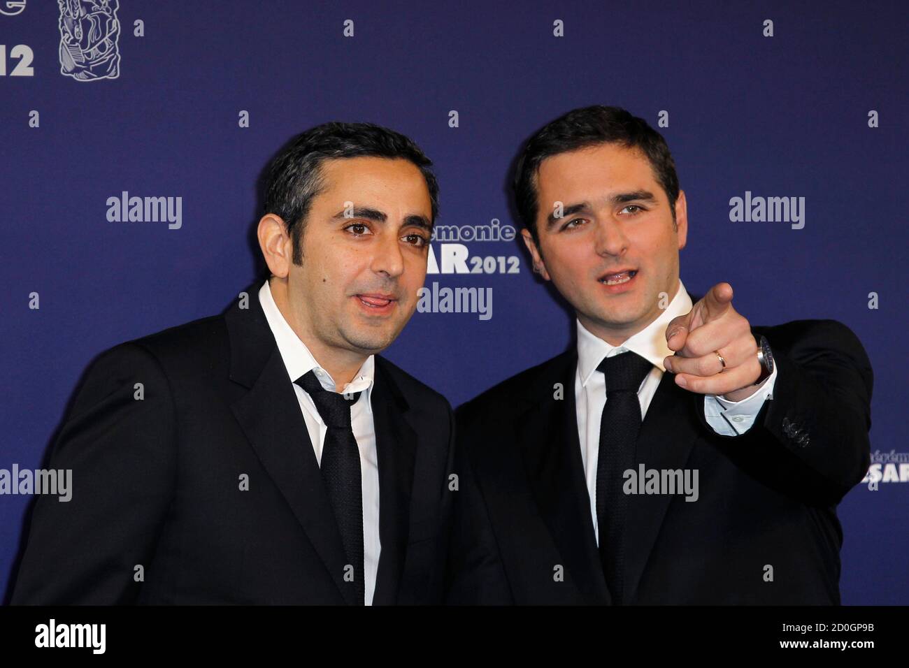 French directors Eric Toledano (L) and Olivier Nakache pose as they arrive at the 37th Cesar Awards in Paris February 24, 2012. REUTERS/Gonzalo Fuentes (FRANCE - Tags: ENTERTAINMENT) Stock Photo