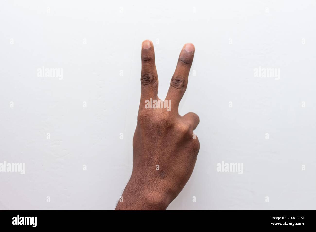 Boy hand showing number two gesture symbol isolated on white background ...