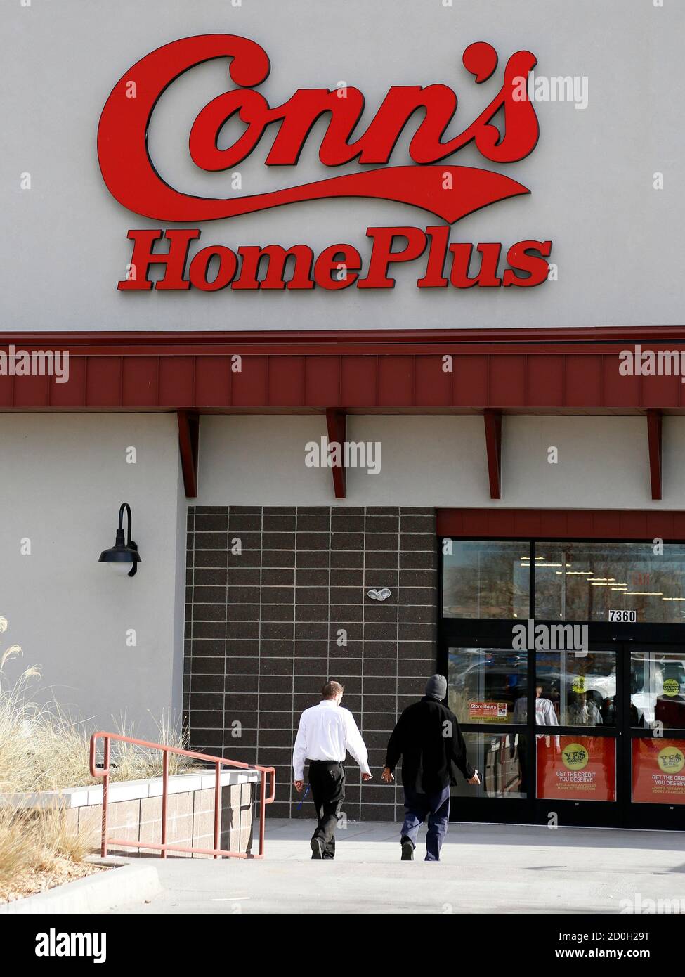 People walk outside a Conn's store in Westminster, Colorado December 9, 2014. Texas-based electronics and home appliance retailer Conn's Inc reported a quarterly loss, withdrew its 2015 profit forecast, and said its chief financial officer had resigned as its mainly low-income customers struggle with credit payments. REUTERS/Rick Wilking (UNITED STATES - Tags: BUSINESS LOGO) Stock Photo