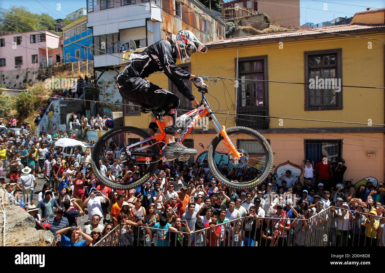A competitor negotiates a drop during the Valparaiso Cerro Abajo urban  downhill mountain bike race in Valparaiso, about 121km (75 miles) northwest  of Santiago, February 19, 2012. More than 60 riders from