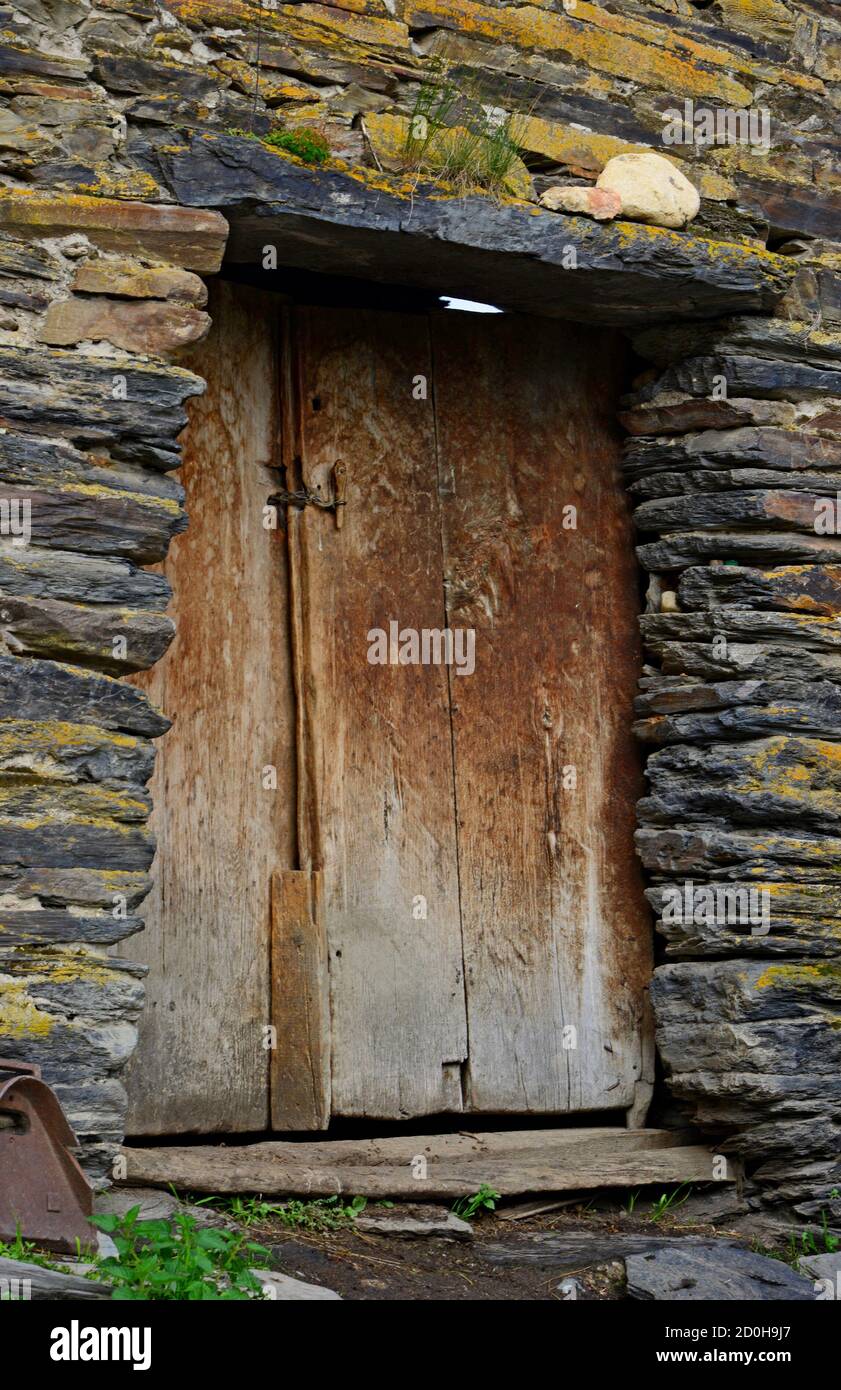 Typical old stone house and wooden door in Ushguli, Svaneti Stock Photo ...
