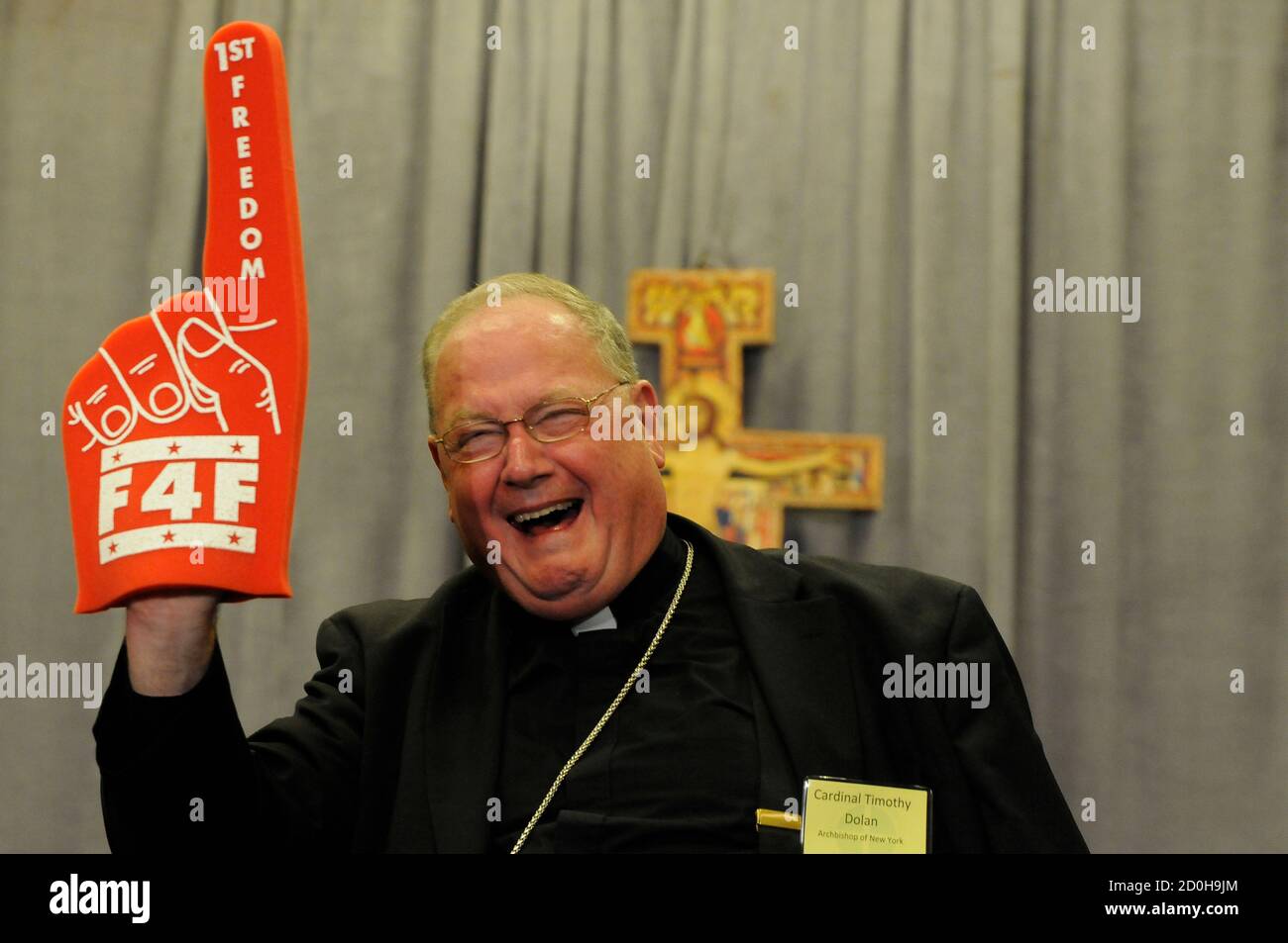 Archbishop of New York Timothy Dolan holds up a foam finger promoting 'A Fortnight for Freedom' conference sponsored by the Catholic church following a afternoon session during the U.S. Conference of Catholic Bishops Annual Spring Assembly in Atlanta, Georgia, June 13, 2012. REUTERS/Tami Chappell (UNITED STATES) BEST QUALITY IMAGE Stock Photo