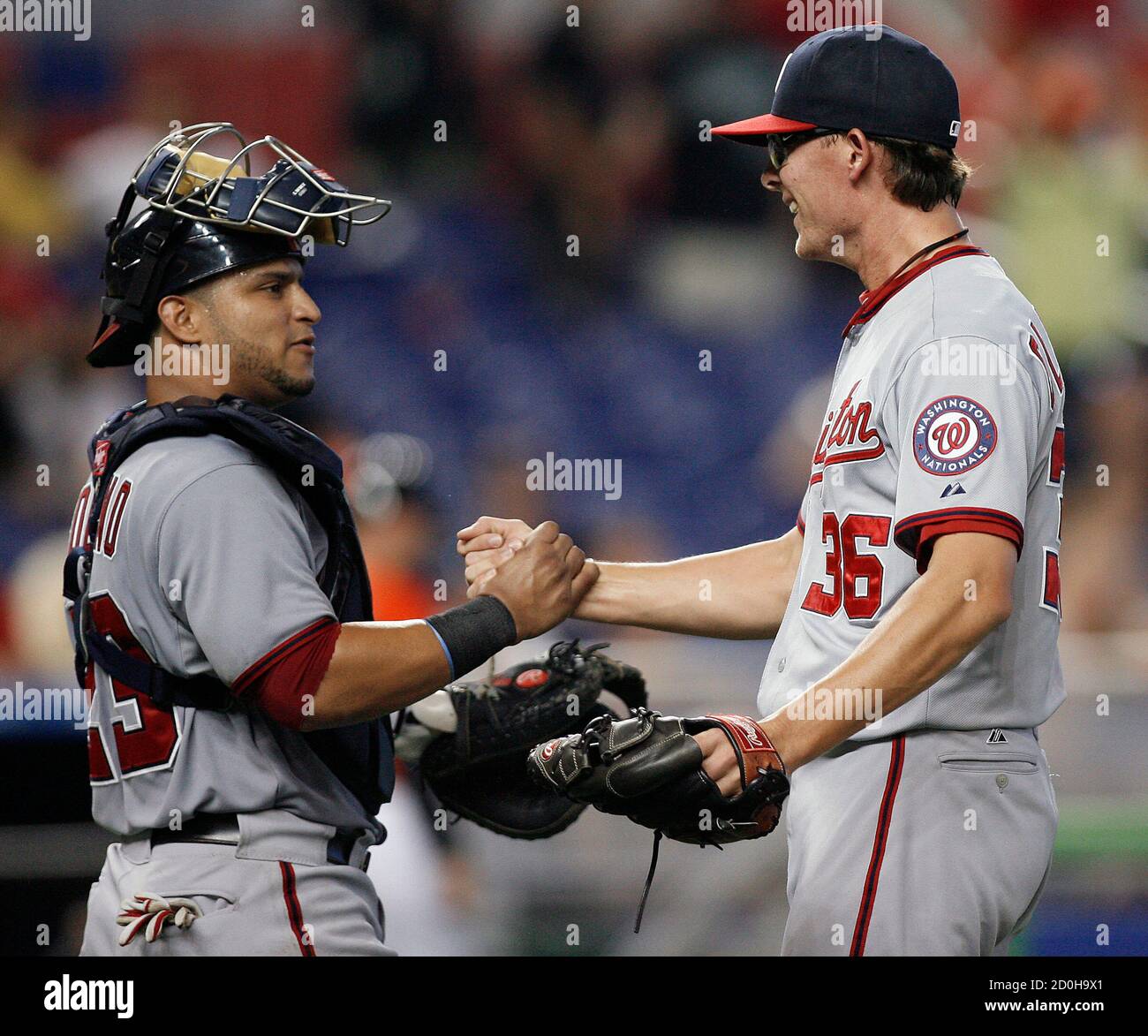 Washington Nationals' catcher Jhonatan Solano (L) greets pitcher Tyler Clippard after their team defeated the Miami Marlins in a MLB National League baseball game in Miami, Florida July 15, 2012. REUTERS/Andrew Innerarity (UNITED STATES - Tags: SPORT BASEBALL) Stock Photo