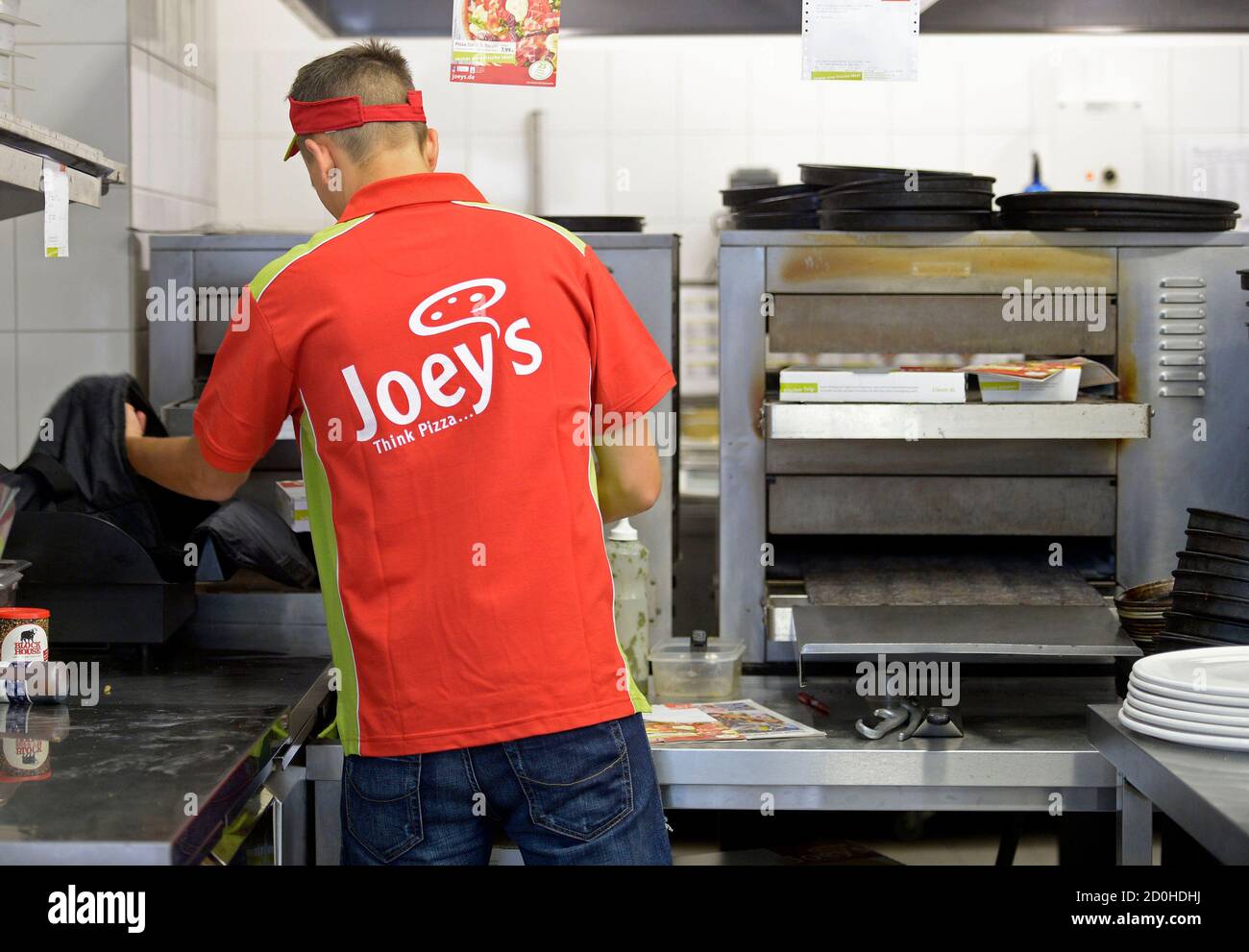 An Employee Puts A Pizza In A Delivery Bag At A Joey S Pizza Delivery Shop In Hamburg August 13 13 Two Years After Launching A Drive For Explosive Growth Across Germany Britain S