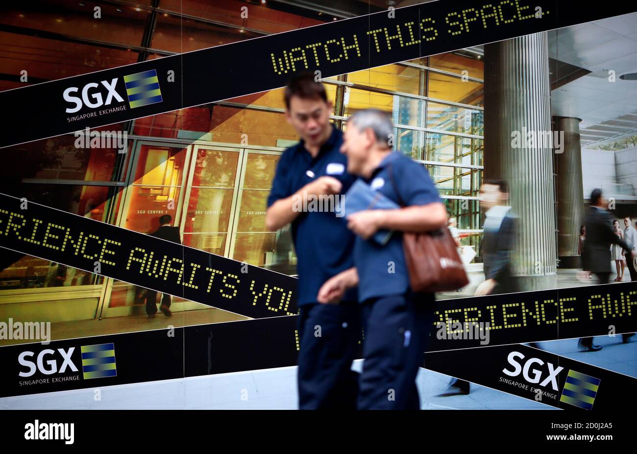 People Walk Past A Logo Of The Singapore Stock Exchange Sgx Outside Its Premises In The