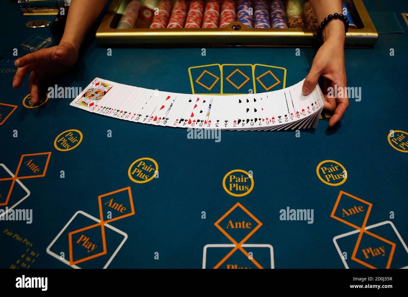 A Dealer Displays Cards On A Gaming Table At Paradise Casino In Incheon August 6 2014