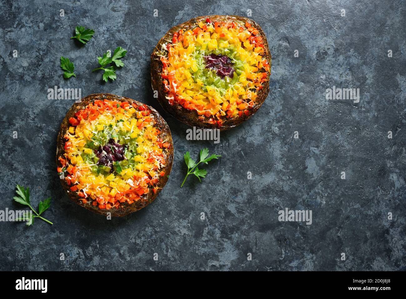 Rainbow veggie bell peppers pizza crust on blue stone background with free text space. Vegetarian vegan or healthy food concept. Top view, flat lay Stock Photo