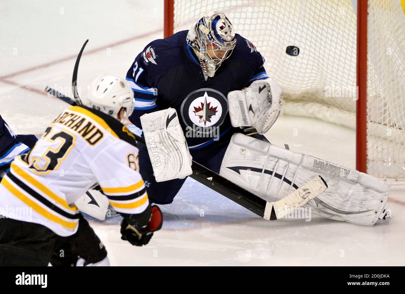 Boston Bruins' Brad Marchand (L) scores the game-winning goal ...
