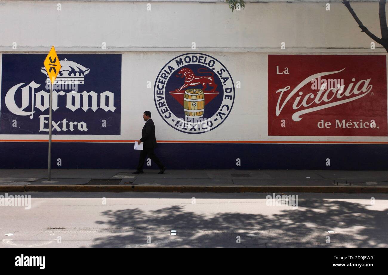 A man walks past the logo of Grupo Modelo in Mexico City July 16, 2013.  After years of complaints from SABMiller, the world's second-largest brewer  but barely a blip on the Mexican