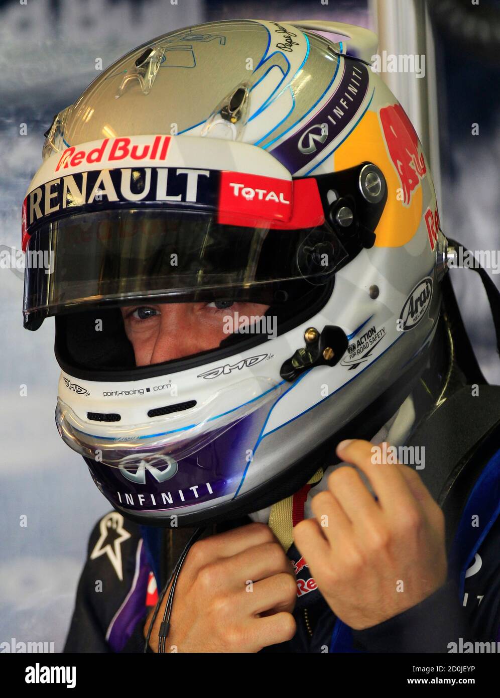 Red Bull Formula One driver Sebastian Vettel of Germany adjusts his helmet  during the third practice session of the Hungarian F1 Grand Prix at the  Hungaroring circuit in Mogyorod, near Budapest July