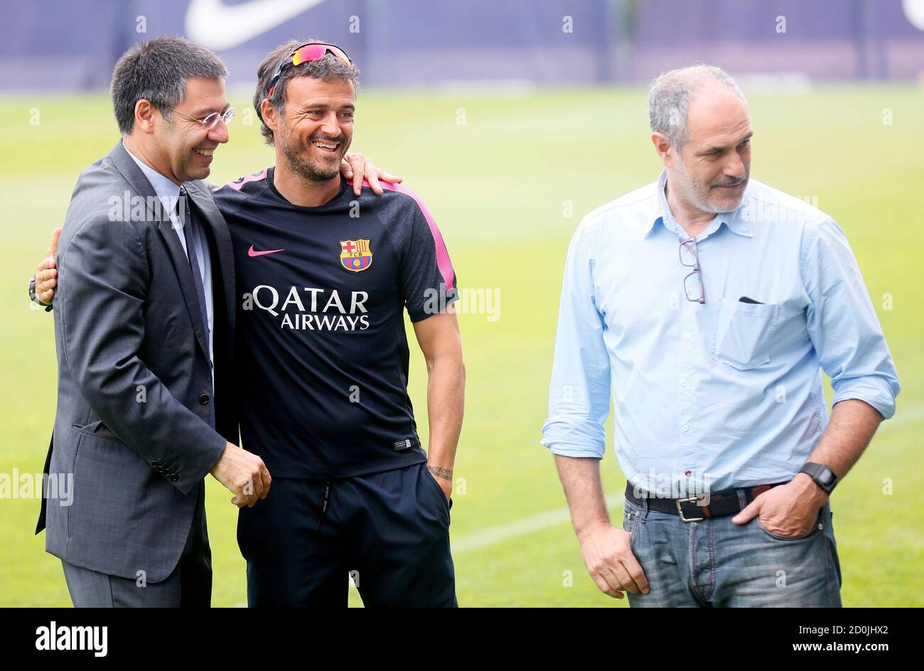 FC Barcelona president Josep Maria Bartomeu (L), coach Luis Enrique (C) and Sports Director Andoni Zubizarreta (R) look to their players during a training session at Joan Gamper training camp, near Barcelona July 25, 2014. REUTERS/Albert Gea (SPAIN - Tags: SPORT SOCCER) Stock Photo