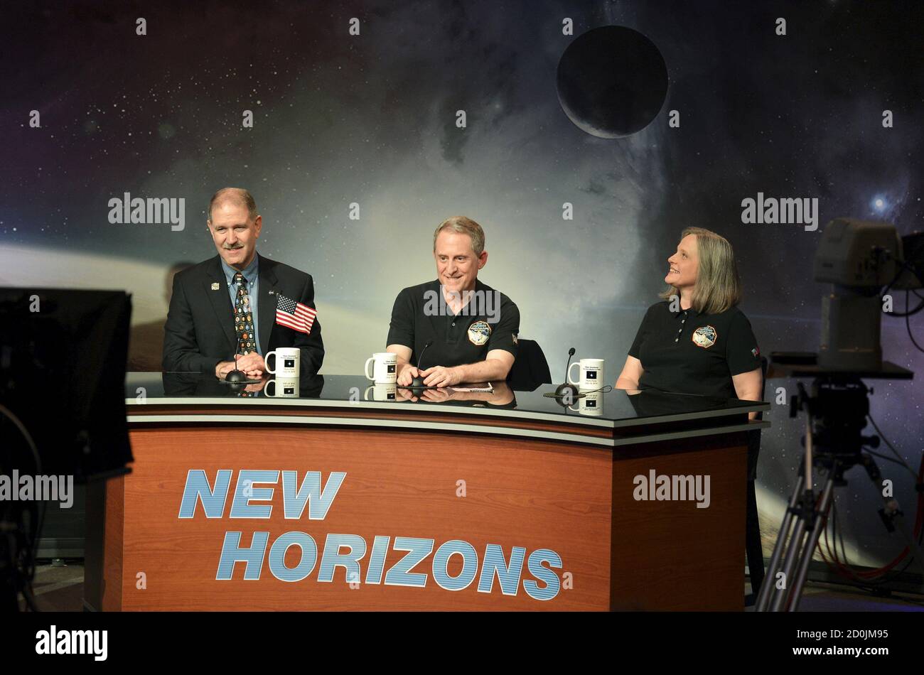 NASA Principal Investigator for New Horizons mission Alan Stern (C) is joined by Associate Administrator John Grunsfeld (L) and Mission Operations Manager Alice Bowman for a news conference as the spacecraft New Horizons approaches a flyby of Pluto, at NASA's Johns Hopkins Applied Physics Laboratory in Laurel, Maryland, July 14, 2015. More than nine years after its launch, a U.S. spacecraft sailed past Pluto on Tuesday, capping a 3 billion mile (4.88 billion km) journey to the solar system’s farthest reaches, NASA said. The craft flew by the distant 'dwarf' planet at 7:49 a.m. after reaching a Stock Photo