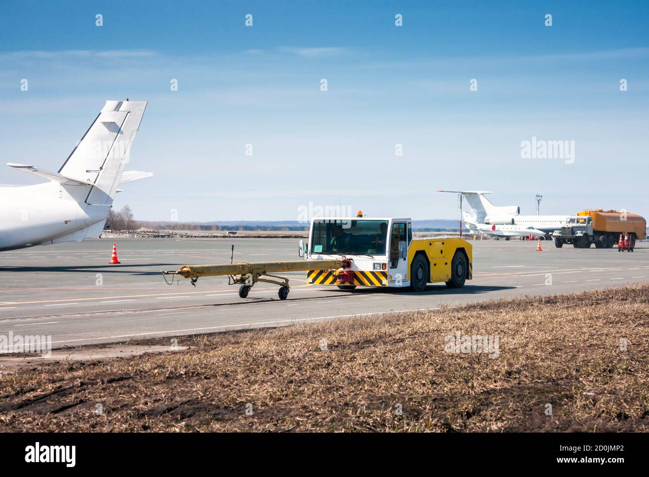 Tow Tractor With Towbar And Tank Truck Aircraft Refuelers Moves At The ...