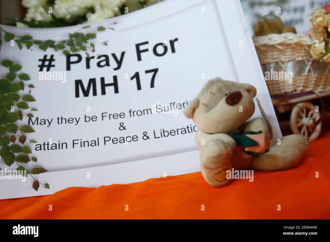 A toy bear rests near a sign during a special vigil for victims of the  downed Malaysia Airlines Flight MH17, inside a Buddhist temple in Kuala  Lumpur July 20, 2014. Ukraine accused
