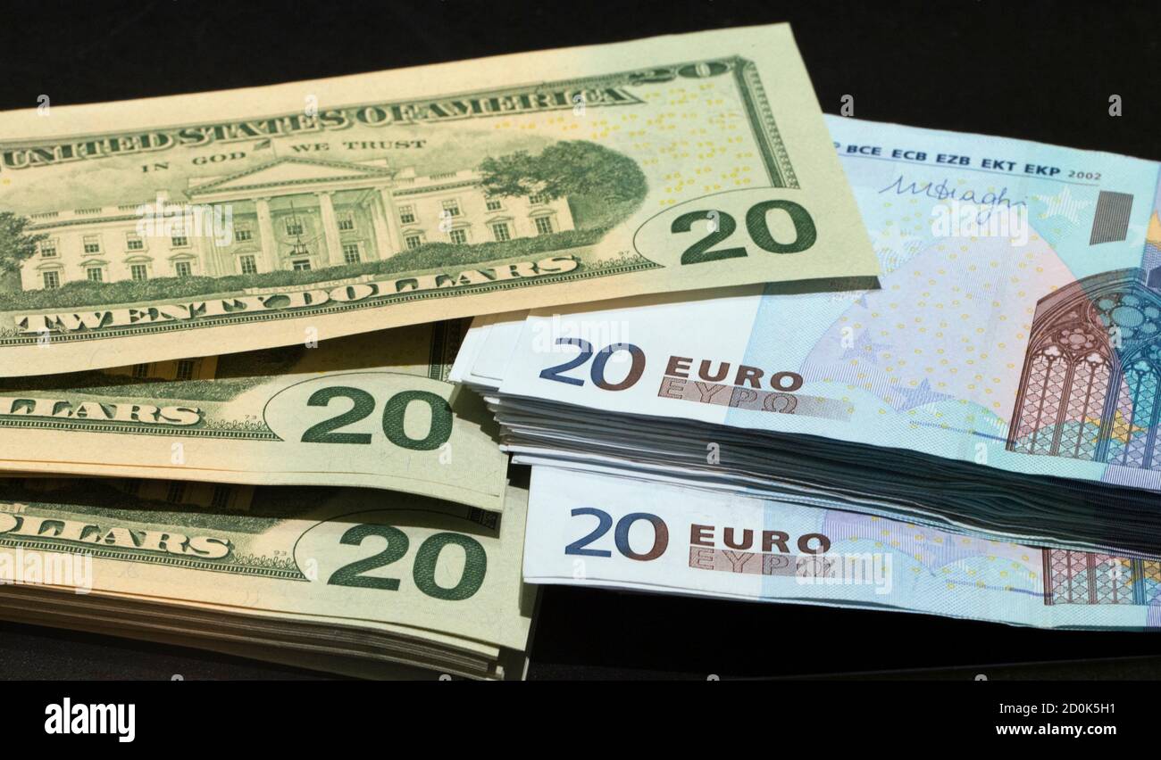 U.S. dollars and euros banknotes are seen in this illustration photo taken  at a change bureau in Paris, October 28, 2014. The global economy will  gradually improve over the next two years