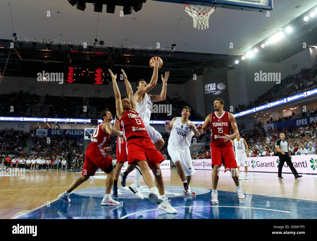 Carlos Delfino (C) of Argentina goes to the basket past Hidayet Turkoglu (R), Ender Arslan (2nd L) and Kerem Tunceri (L) of Turkey as Roman Gonzalez (2nd R) of Argentina follows during their FIBA exhibition basketball game in Ankara August 23, 2010. The FIBA World Championship will take place in Turkey from August 28 to September 12. REUTERS/Umit Bektas (TURKEY - Tags: SPORT BASKETBALL) Stock Photo