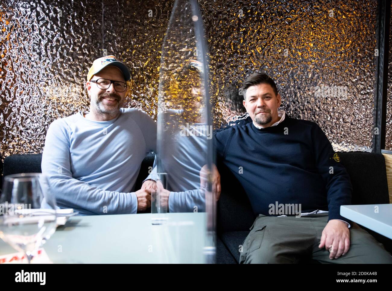 Hamburg, Germany. 02nd Oct, 2020. TV chef Tim Mälzer (r) and Patrick Rüther, restaurateur and business partner, sit at a table in the newly designed rooms of his restaurant 'Bullerei'. Mälzer and his business partner Rüther reopened on 03.10.2020 after a six-month compulsory break. Credit: Christian Charisius/dpa/Alamy Live News Stock Photo