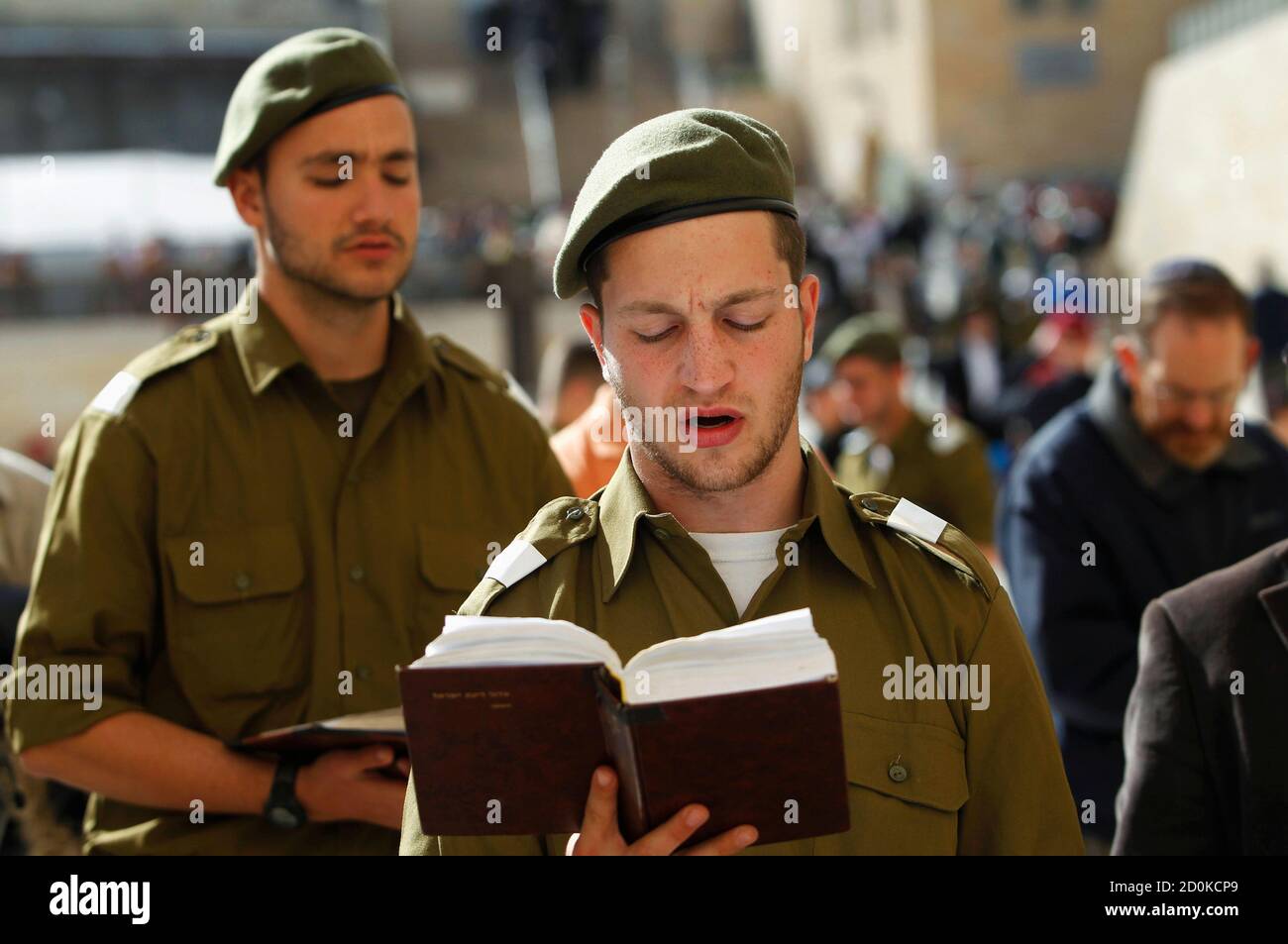 Israeli soldiers pray at the Western Wall, Judaism's holiest prayer site, in Jerusalem's Old City February 22, 2012. The Israeli Defence Force (IDF) has always been a 'Jewish' army. Its rations are kosher, its chaplains are rabbis, and it operates - with the exception of wartime - around the festival calendar. It has never drafted soldiers from Israel's 20-percent Arab minority. But its Jewish identity has always been more cultural than religious. IDF personnel data suggests that's changing. Around 57 percent of Israel's Jewish majority, census figures show, define themselves as religiously ob Stock Photo