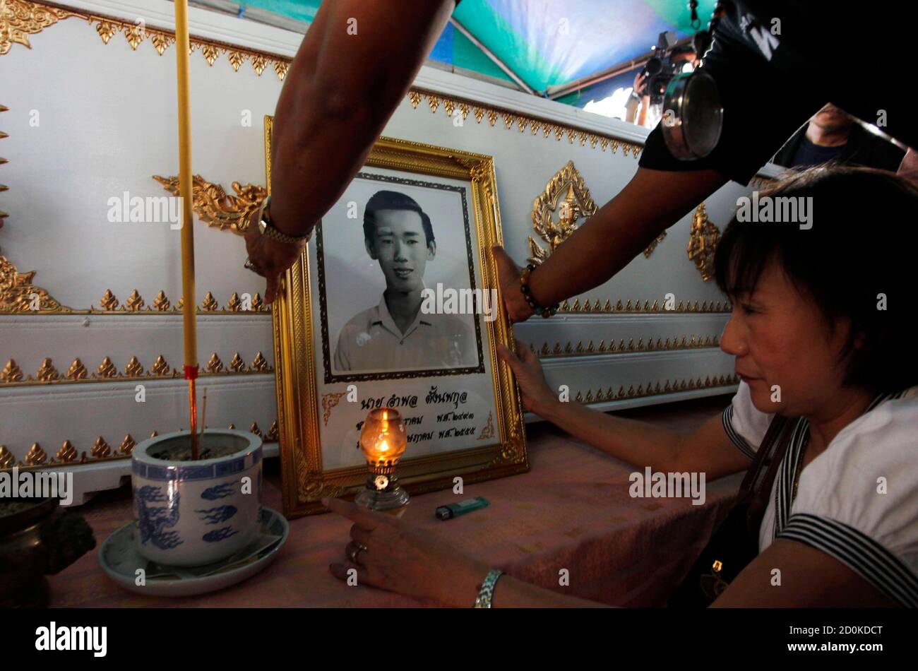 A Woman Prays In Front Of The Coffin Of Amphon Tangnoppaku Outside The Criminal Court In Bangkok May 9 2012 Amphon Who Was Jailed For 20 Years After Being Found Guilty Of In sentence case, most major and minor words are lowercase (proper nouns are an exception in that they are always capitalized).