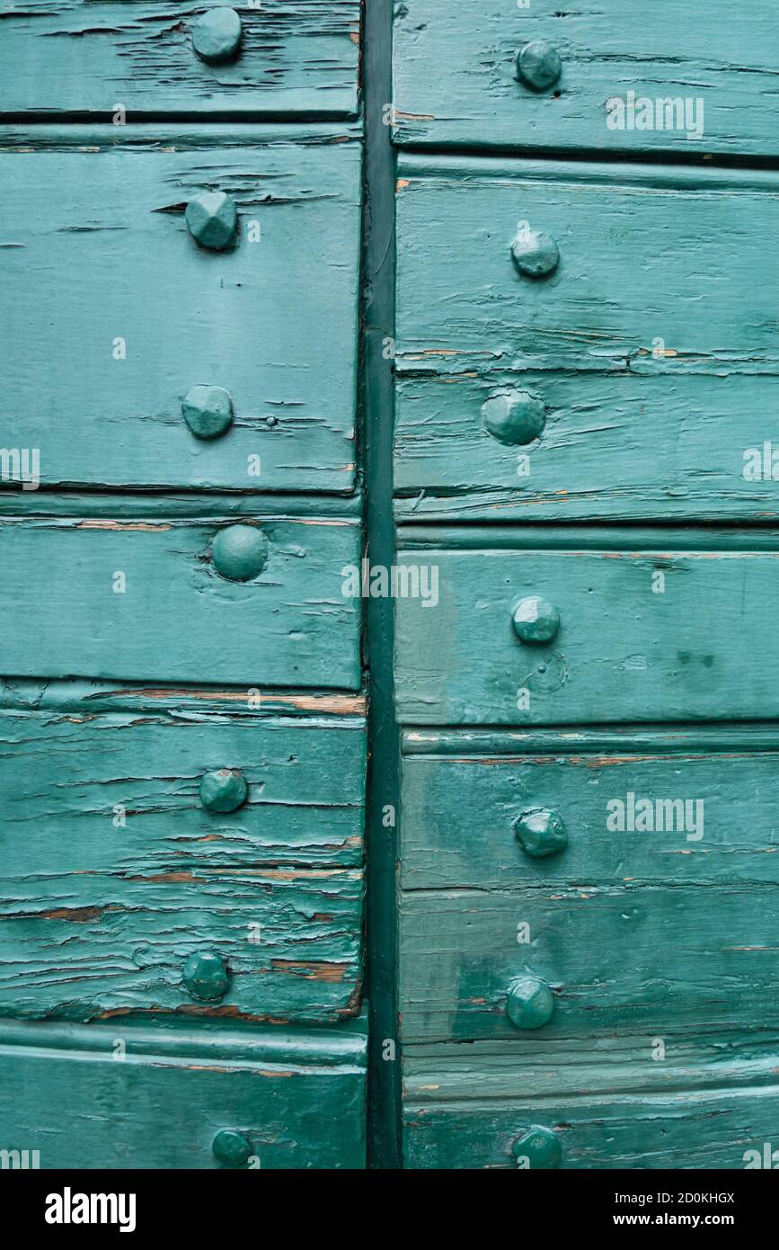 Closed Wood gate doors painted in green and exposed bolts Stock Photo
